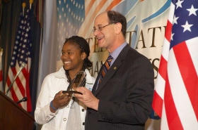 One of the youth winners, rapper Lai Lai, is presented her award by Congressman Brad Sherman.